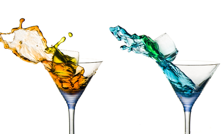 Shots splashing aroun in cocktail martini glassesの写真素材