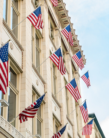 American flags hung off side of building complex in Denver, Coloradoの写真素材