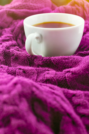 Cup of warm tea on a purple blanket. Selective focus.の写真素材