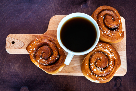 Coffee with cinnamon roll. Top view.の写真素材