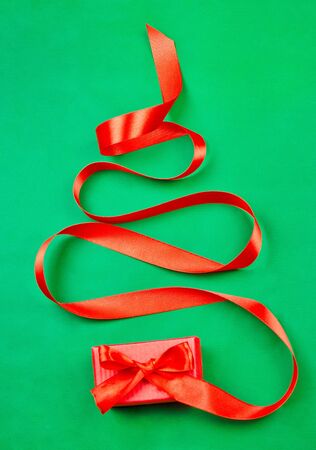 Christmas tree made of a gift's red ribbon. Flat lay, concept of Christmas time.の写真素材