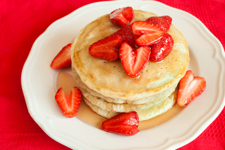 Pancakes with strawberry on a white wooden table. Top view. Selective focus.の写真素材