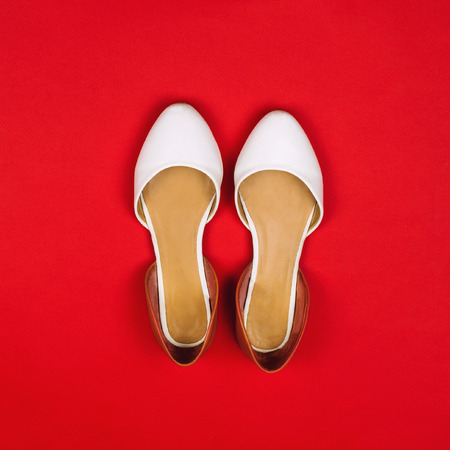 Flats on a red background. Fashion concept, square image, flat layの写真素材