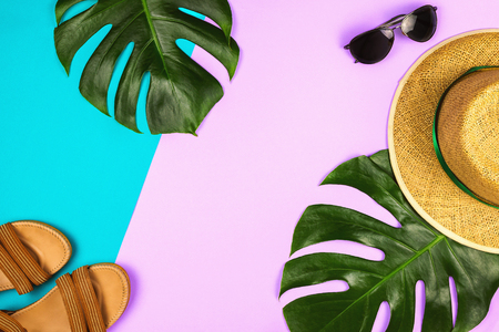Flatlay with monstera leaves, straw hat and other accessories, summer and holiday concept, copyspaceの写真素材