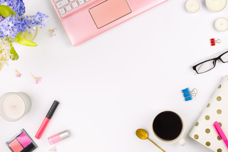 Flatlay with a laptop, flowers, glasses, cup of coffee and other accessories, concept of a work space. White backgroundの写真素材