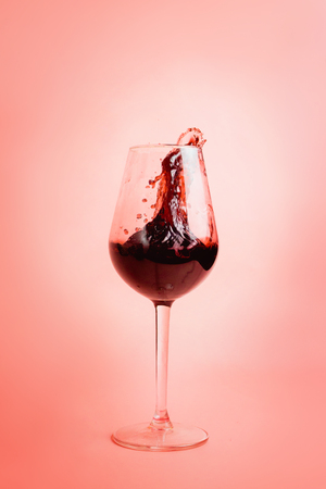 Red wine splash in a glass, dynamic picture, selective focus.の写真素材