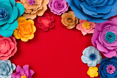 Beautiful floral spring or summer background. Papercraft flowers on red background, top view, flat lay, copyspaceの写真素材