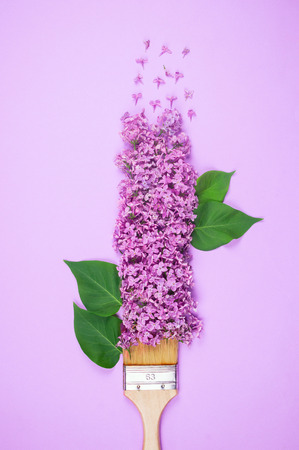 Wooden bristle brush with purple lilac flowersの写真素材