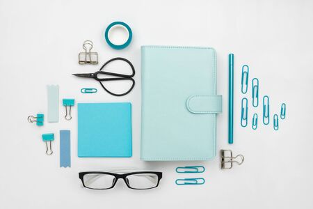 Flatlay arrangement with various office and stationary tools on whiteの写真素材
