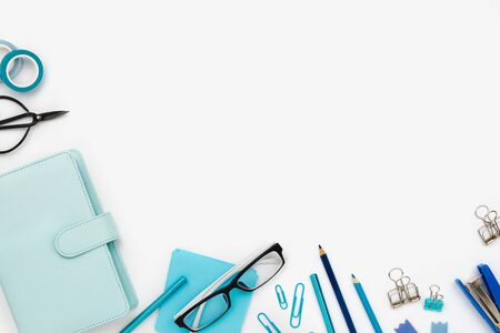 Flatlay arrangement with various office and stationary tools on white: planner, note paper, pens, pencilc etc. Copyspaceの写真素材