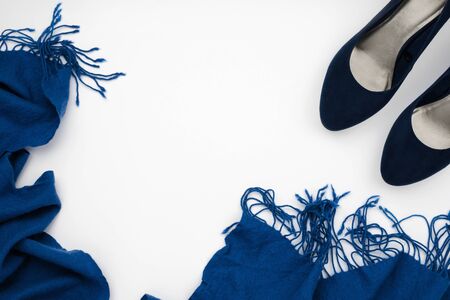 Flatlay frame arrangement with blue high heeled shoes and blue scarf, fashion concept, white background, copyspaceの写真素材