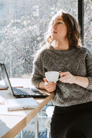 portrait of young adult woman working in a coffeeshop, selective focusの写真素材