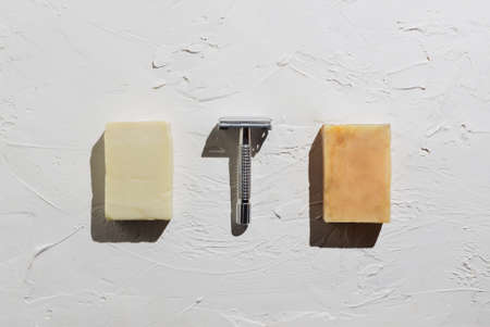 Flatlay of sustainable metal razor and homemade soapの写真素材