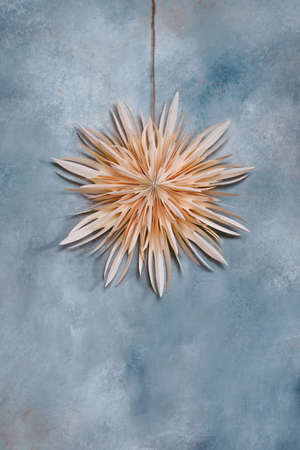 Paper star ornament on the wall, minimalistic festive decorationsの写真素材