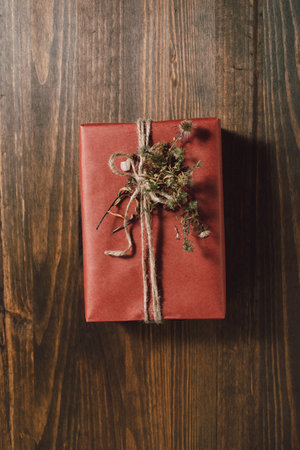 Sustainable gift wrapping flat lay, gift box packed and decorated with kraft paper, ribbon and dried...