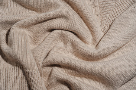 Flat lay of knitted cotton beige sleeveless topの写真素材