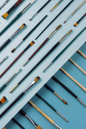 op view of various painting brushes on blue backgroundの写真素材