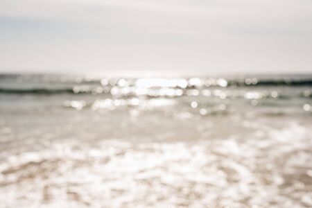 Nature background - blurry view of sun sparkling on oceanの写真素材