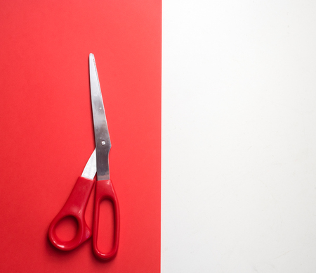 High angle view of red scissors on red and white backgroundの写真素材