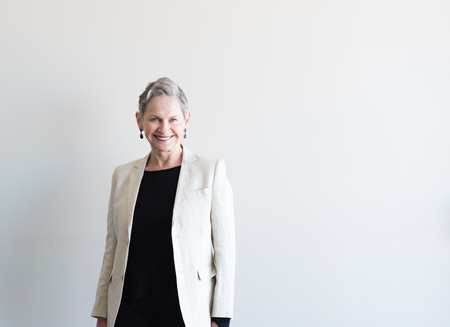 Half length view of beautiful older woman with short grey hair and linen jacket against neutral backgroundの写真素材