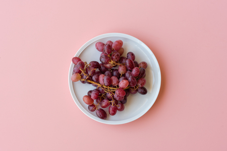 Directly above view of red grapes on pink backgroundの写真素材
