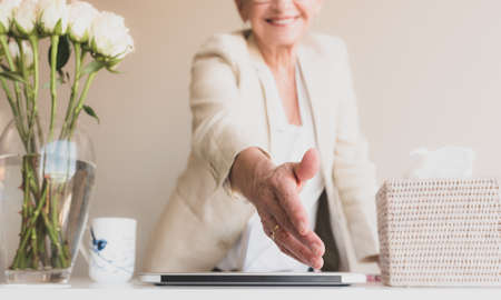 Cropped view of professional woman reaching out to shake hands -personal point of view and selective focusの写真素材