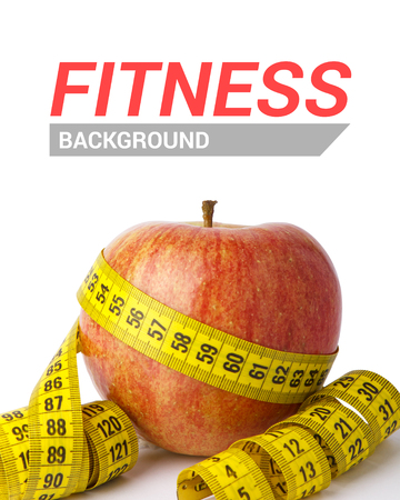 Red apple with yellow measuring tape, isolated on whiteの写真素材