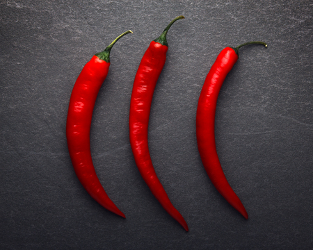 Red chili pepper on black background