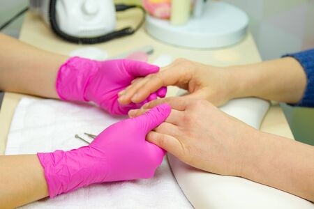 Closeup shot of a woman in a nail salon receiving a manicure. Woman getting nail manicure. 
の写真素材