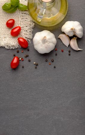 Pasta and ingredients for cooking on dark background.の写真素材