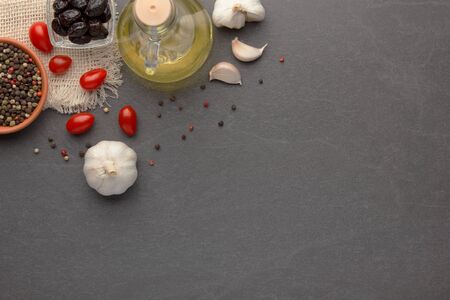 Italian pasta, olive oil, cheese, pepper, basil on stone tableの写真素材