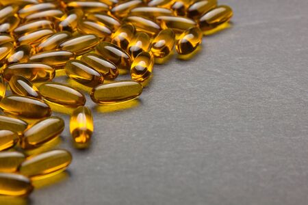 Close up of capsules Omega 3 on black background.の写真素材