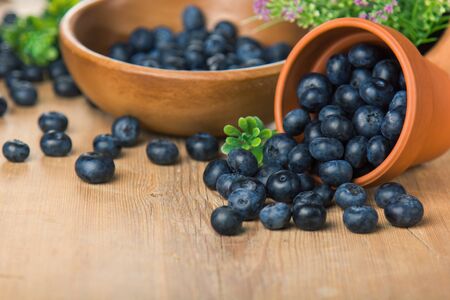 Blueberry on wooden table background. Ripe and juicy fresh picked blueberries closeup. Berries closeupの写真素材