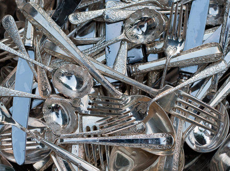 big pile of silver spoons, forks and knives の写真素材