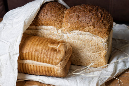 different bread on the wooden table, flour, sackcloth, bowlの写真素材