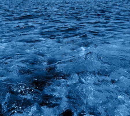 Surface ocean blue water background. Natural water paradise. Ocean nature depth and tranquility.の写真素材