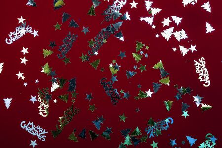 Scattered decorative cuts on a vine red color background, Christmas, New year decorationsの写真素材
