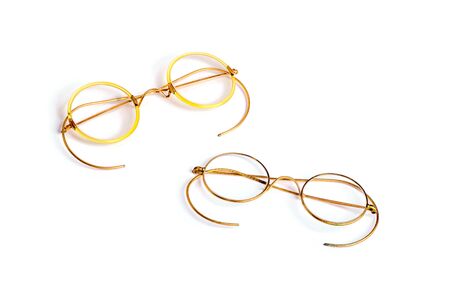 Couple of golden old fashion glasses isolated on white backgroundの写真素材