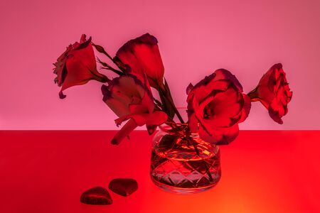 Red colored picture of flowers in vase and heart shaped chocolates, Valentines Dayの写真素材