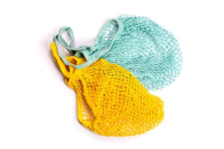 Yellow and blue string mesh reusable bags isolated on white.