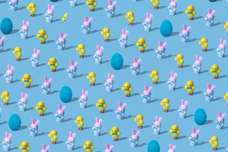 Trendy Easter pattern made of rabbits hares, chicken and egg woolen toys on blue background in minimal style. Easter concept in minimal style.の写真素材