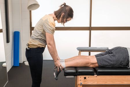 Man having chiropractic back adjustment. Physioterapy, osteopathy, alternative medicine pain relief...