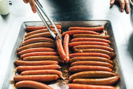 Grilling sausages on barbecue grill in the garden. Beef sausages. Public BBQ place in Australia. Picnic in park.の写真素材