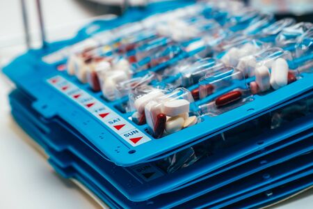 Pills in blisters for every day of the week for the morning, day, night time. Medications for patients in a hospital.の写真素材