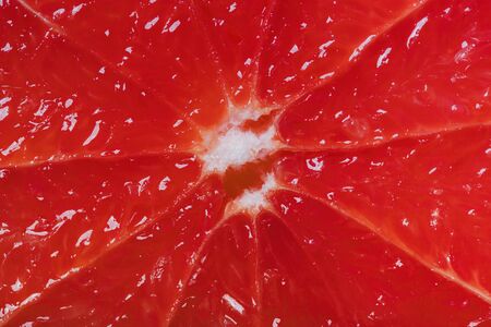 Cutted grapefruit background. Red juicy surface. Close up shot.の写真素材