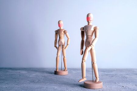 Wooden dummies walking in distance in medical masks. Self hygiene and Social distancing concept. COVID-19 coronavirus pandemic outbreak.の写真素材