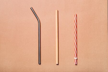 Different kinds of straws. Reusable bamboo, stainless steel and single-use plastic. Zero-waste, sustainability concept.の写真素材