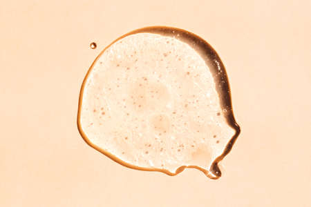 Squeezed cosmetic clear cream gel texture. Close up photo of transparent drop of skin care product....