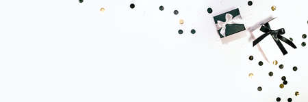 Black and white gift or present boxes and confetti on white background. Flat lay composition for...