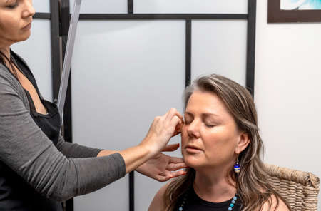 Make up artist work in her beauty visage studio salon. Woman applying by professional make up...